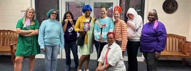 9 adults dressed up as Inside Out characters-disgust, sadness, fear, joy, Riley, anger, anxiety, embarrassment, and ennui