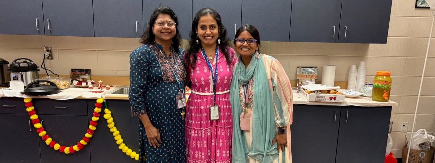 3 women in traditional India outfits.