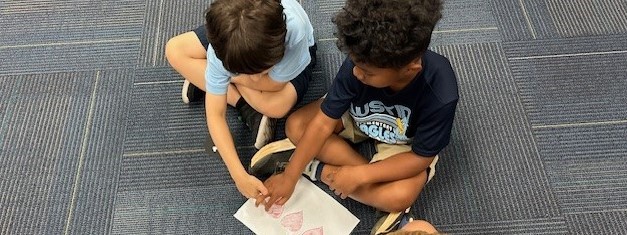 2 boys with a picture of hearts