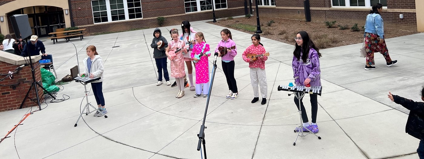 students playing beals and guitar