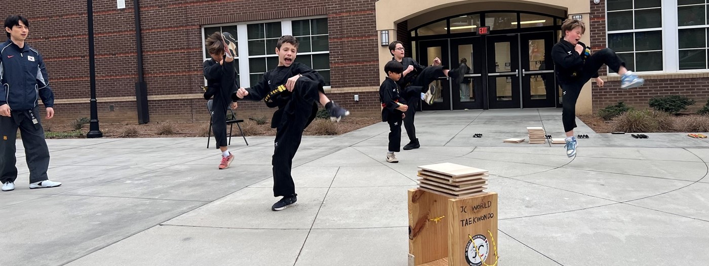 students karate kicking